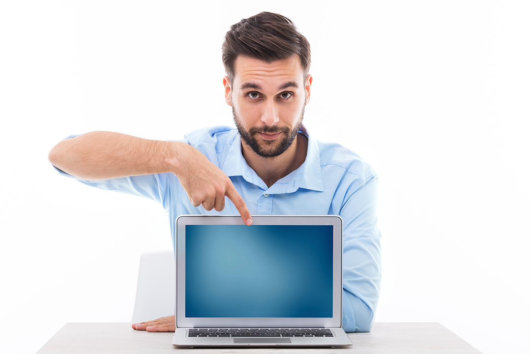 Young man at desk with laptop