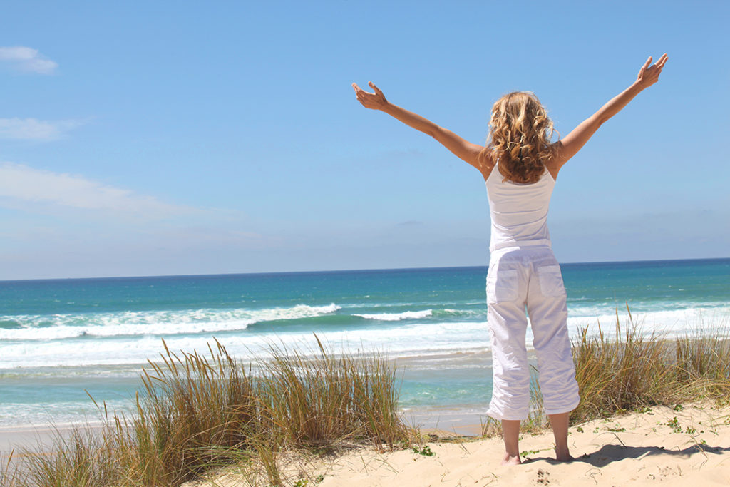 A woman feeling free at the beach