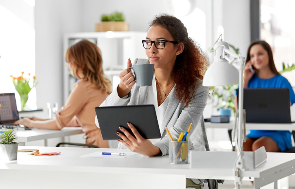 businesswoman with tablet pc and coffee at office