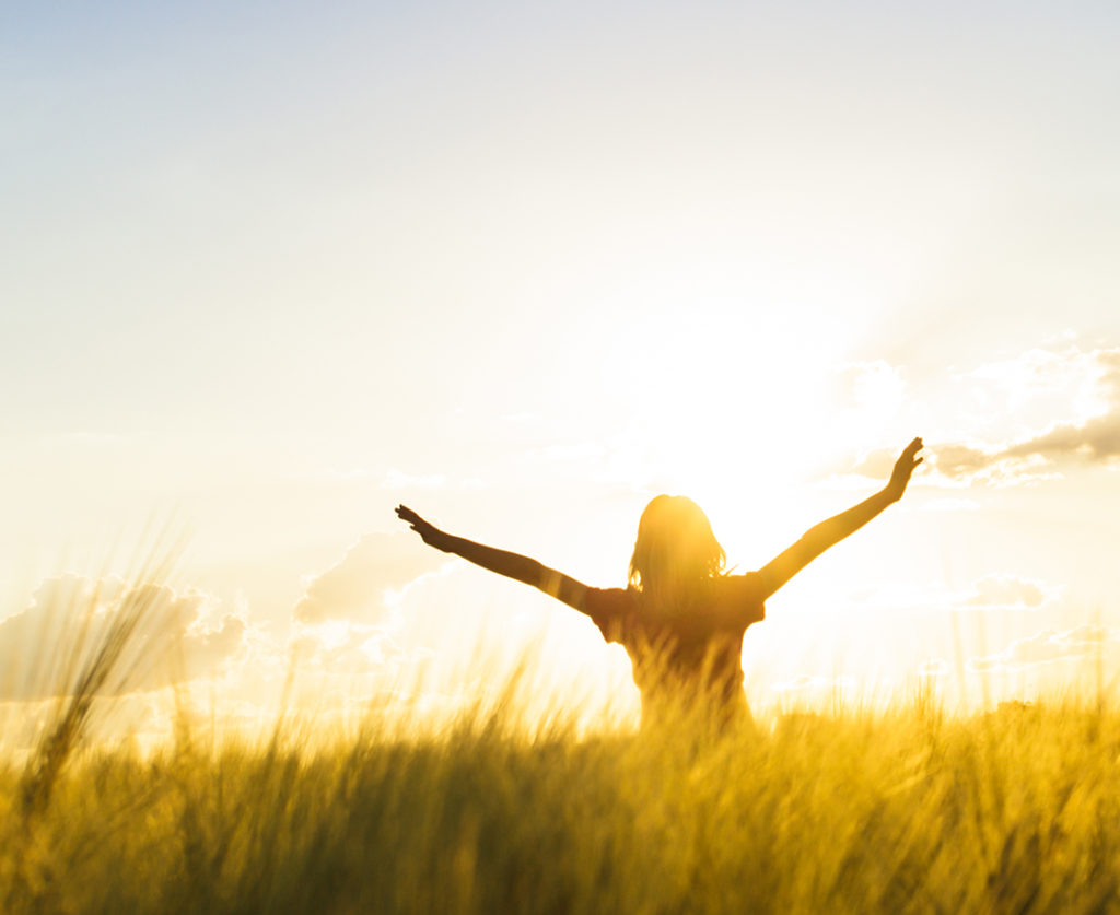 Teenage girl enjoy with sunshine in wheat field