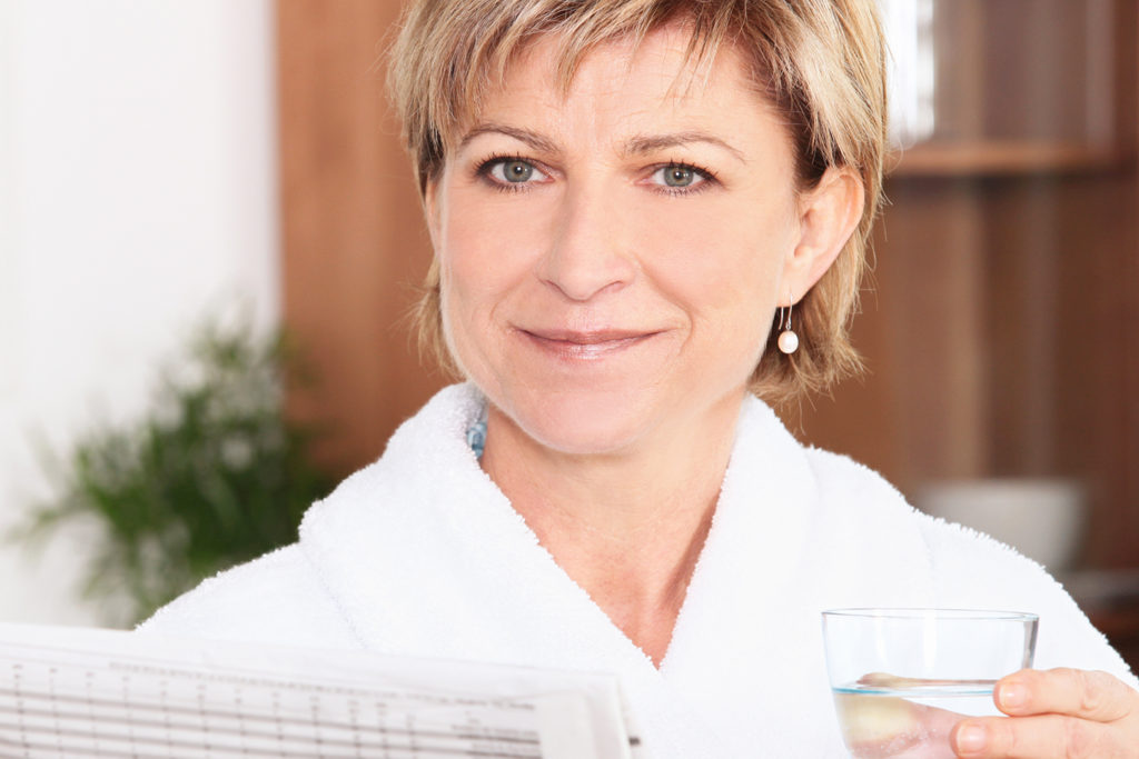 A woman holding a drink