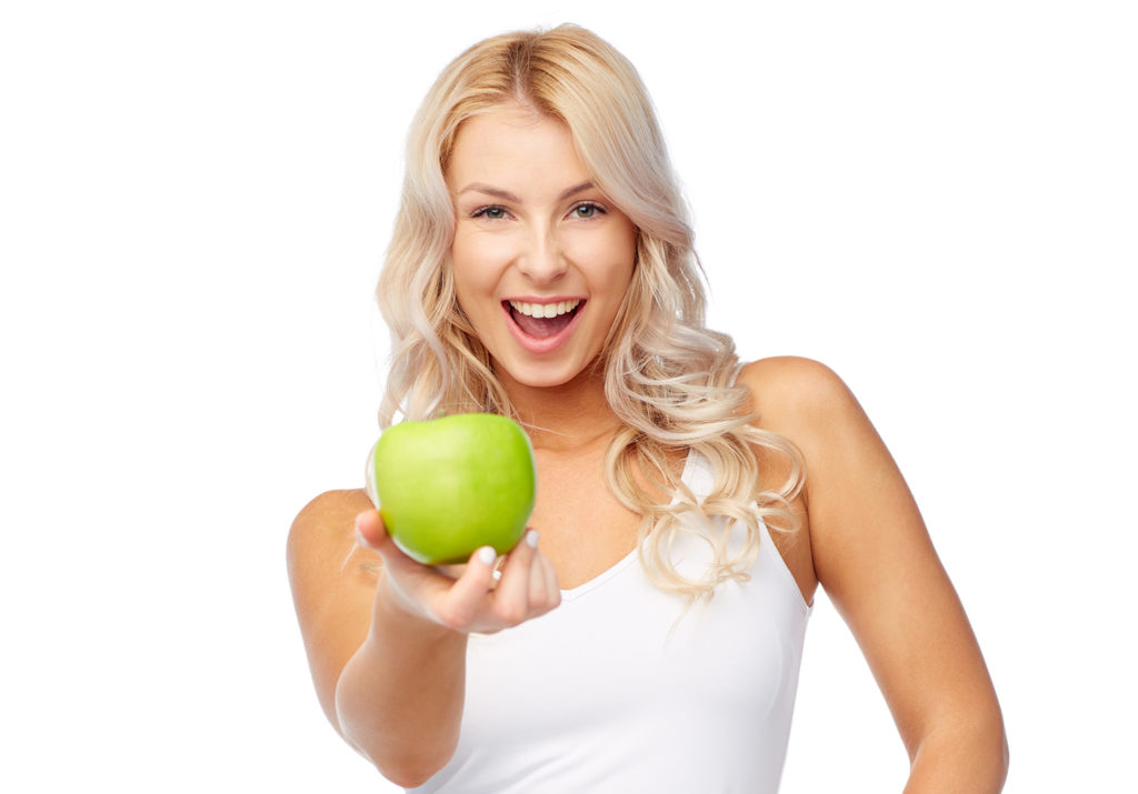 happy beautiful young woman with green apple